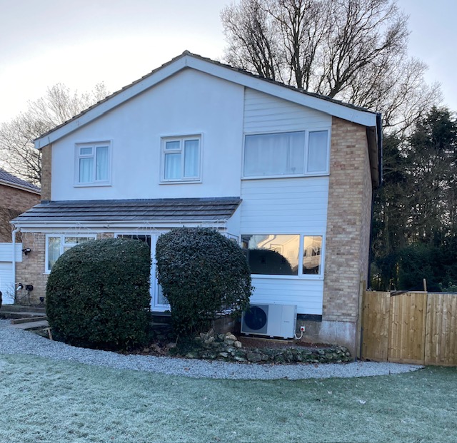 Front image of a 1980s home and its garden